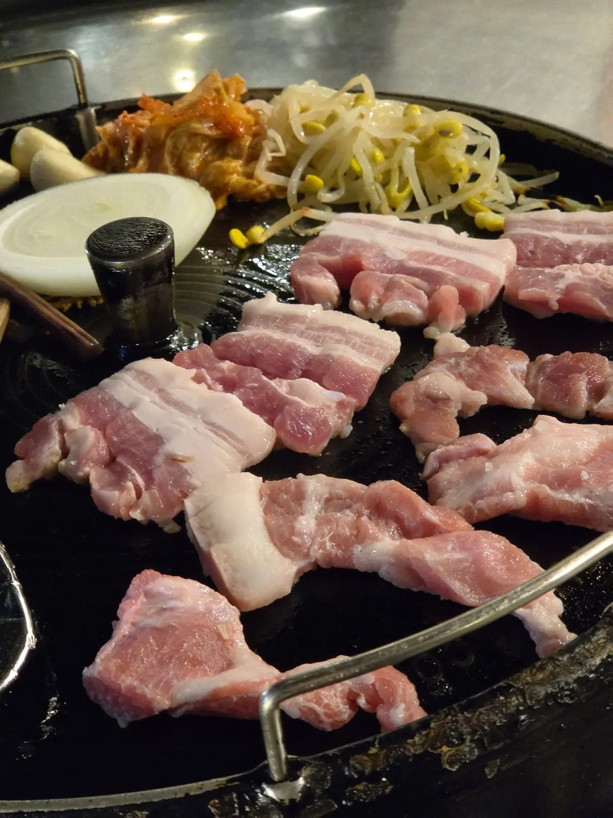 Nonhyeondon, Nonhyeon — thick pork belly on a cast-iron lid grill, grade-1 Korean pork, football on the TV