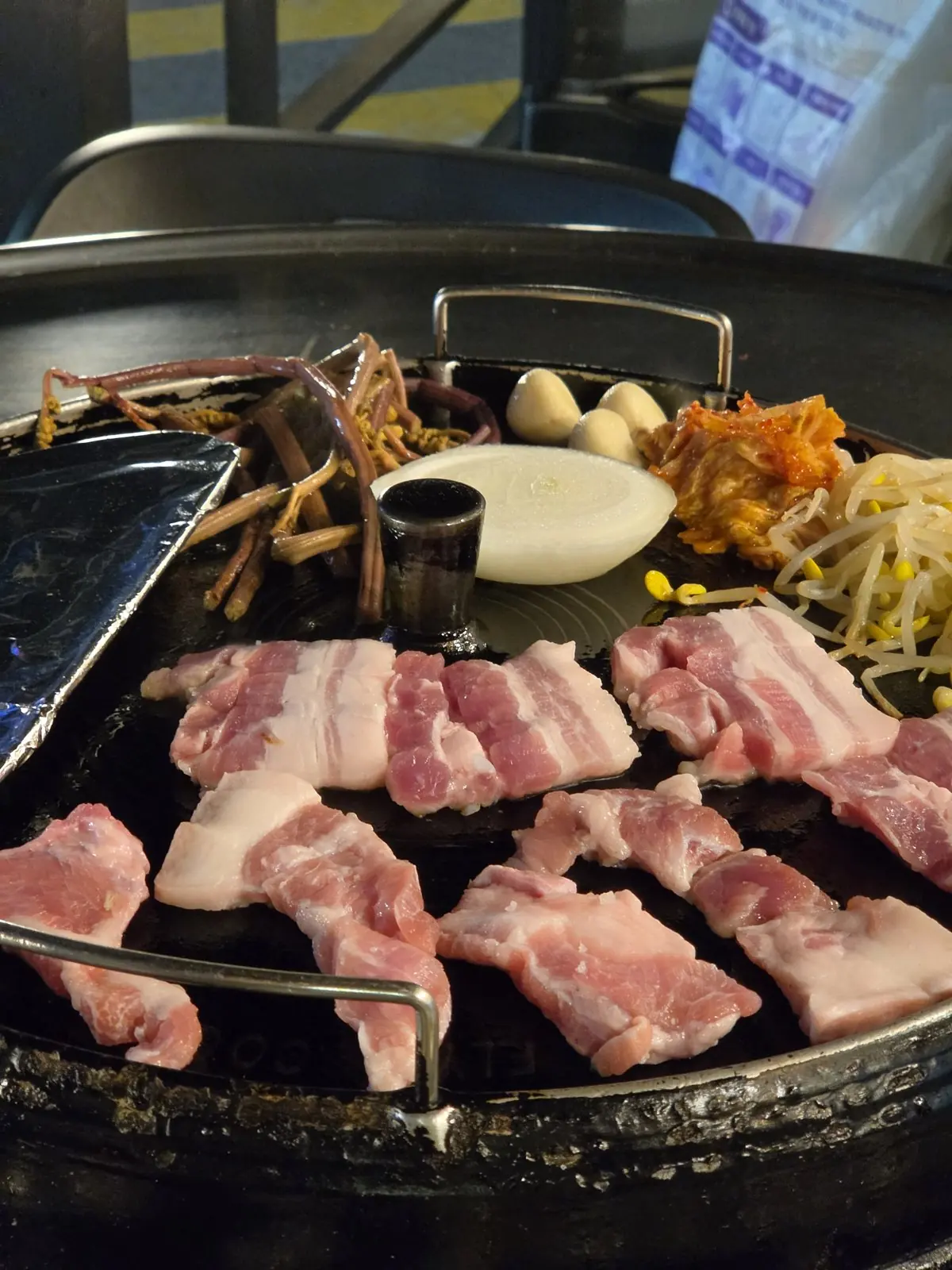 Nonhyeondon, Nonhyeon — thick pork belly on a cast-iron lid grill, grade-1 Korean pork, football on the TV — Nonhyeondon Nonhyeon