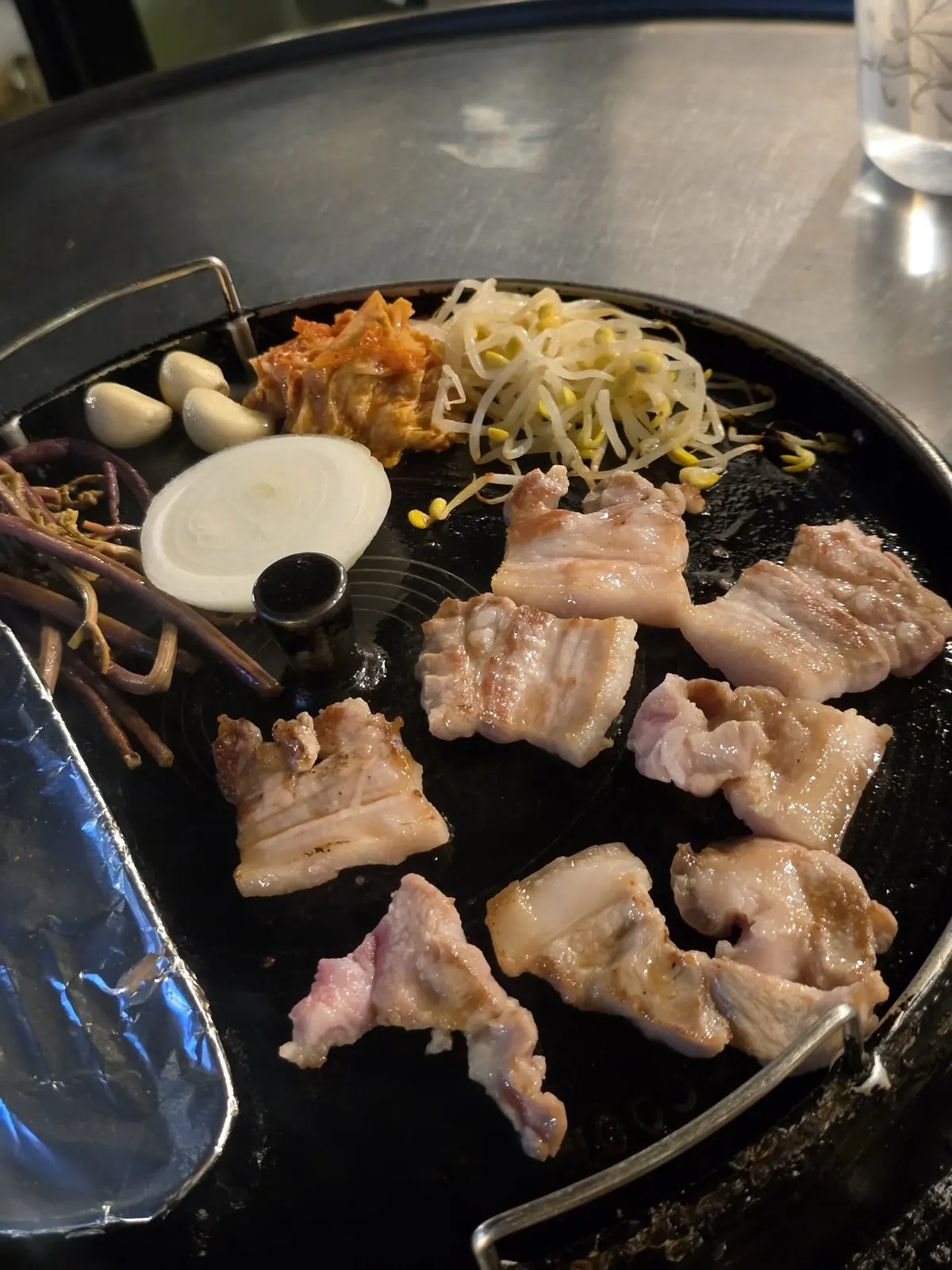 Nonhyeondon, Nonhyeon — thick pork belly on a cast-iron lid grill, grade-1 Korean pork, football on the TV — Nonhyeondon Nonhyeon
