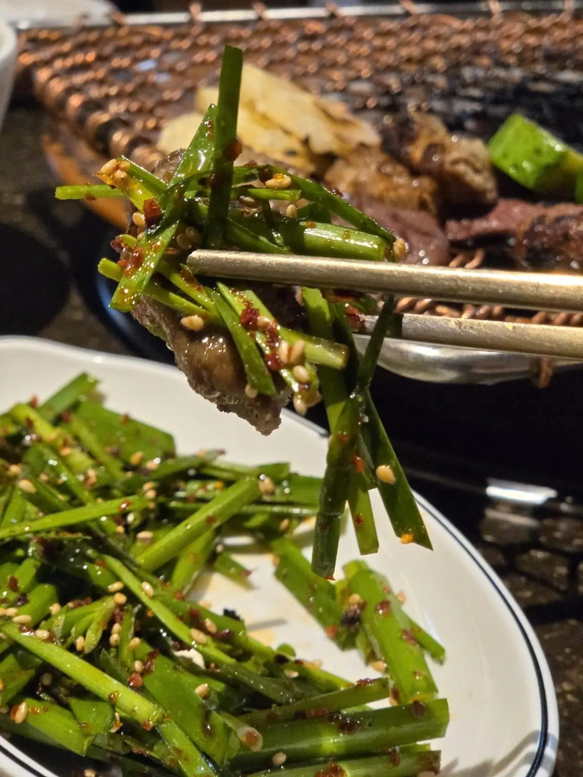 Gopchang topped with chive salad, one bite — Bangbae Yanggopchang (방배양곱창), Banpo branch