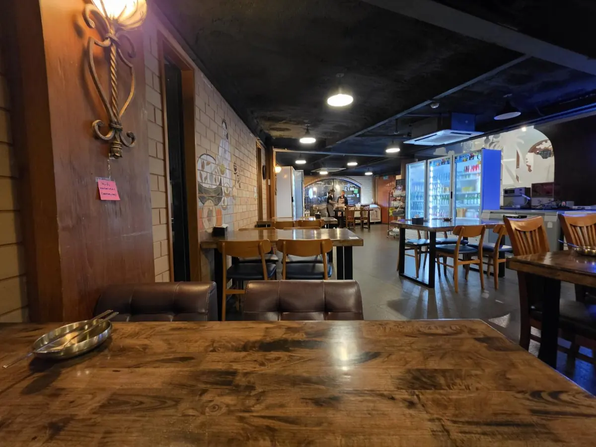 Inside, with wooden tables — WuRim Korean Slow Food (우림), Bangkok