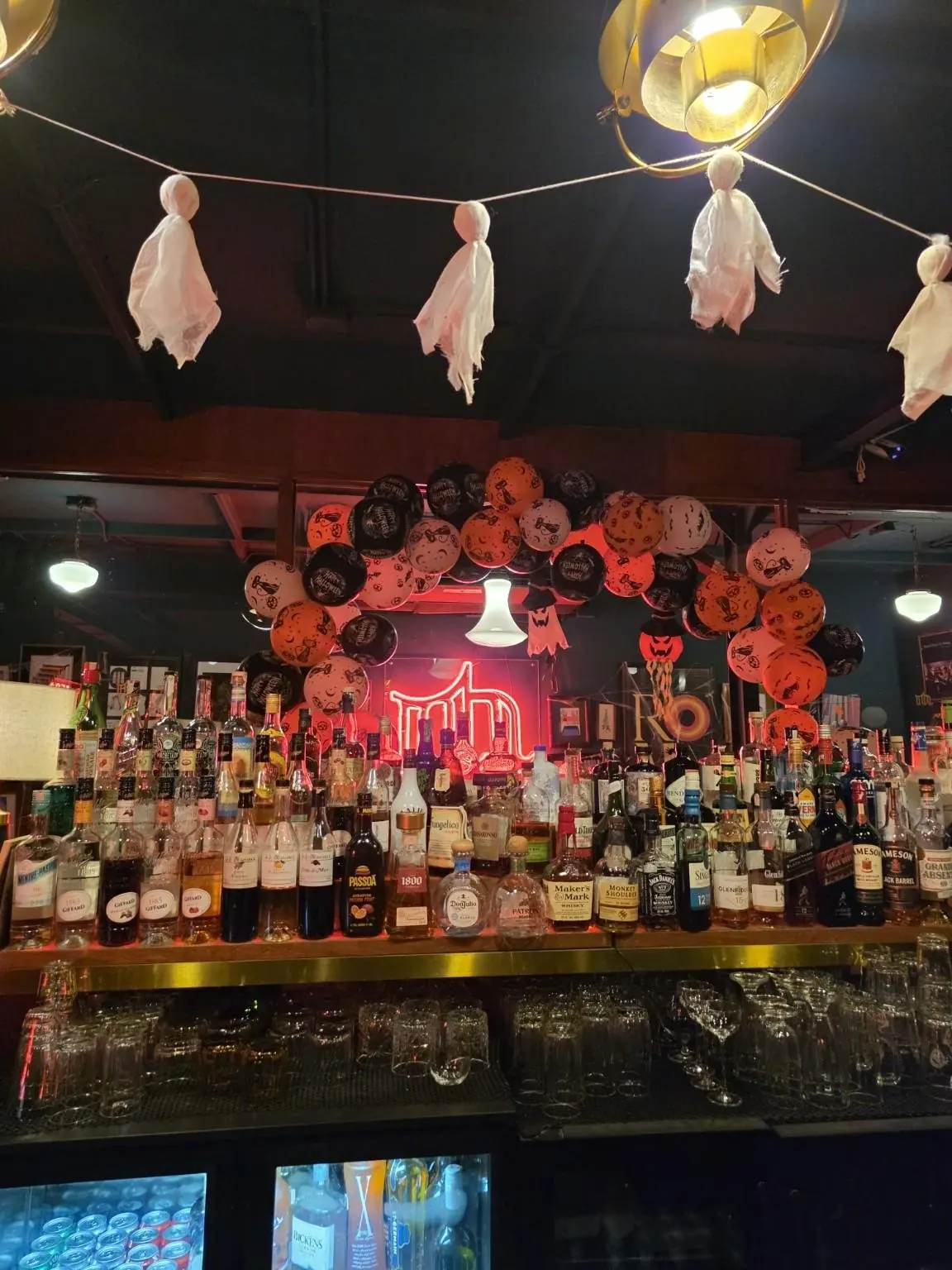 Mutual Bar's bar, full of bottles and Halloween decorations. — Mutual Bar, Sukhumvit 24 (5th floor), Phrom Phong, Bangkok