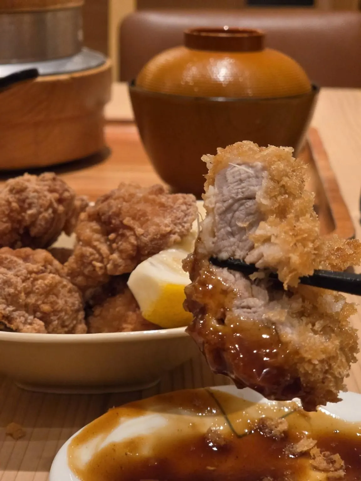 A piece of tonkatsu dipped in sauce. — Tonkatsu Wako Siam Center, Bangkok