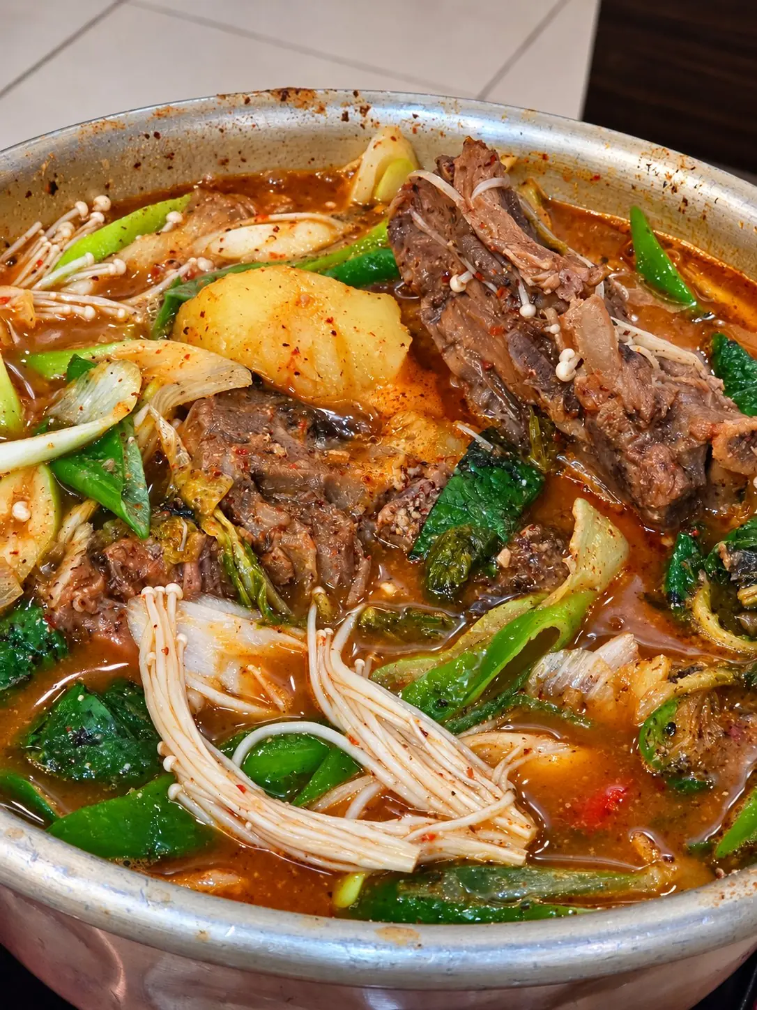 A pot with potatoes, vegetables and big pork bones. — Dae Jang Geum, Prasanmit Plaza, Sukhumvit Soi 23, Asok, Bangkok