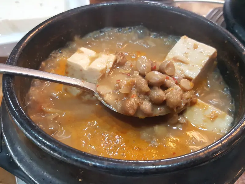 Bubbling fermented soybean stew in an earthenware pot