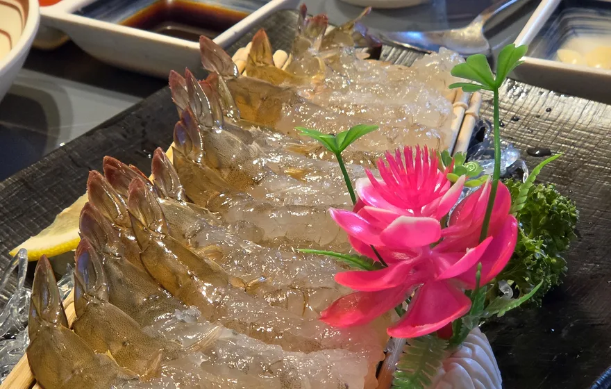 Raw shrimp sashimi fanned out on a bamboo mat at Haehwaro, Bangi-dong